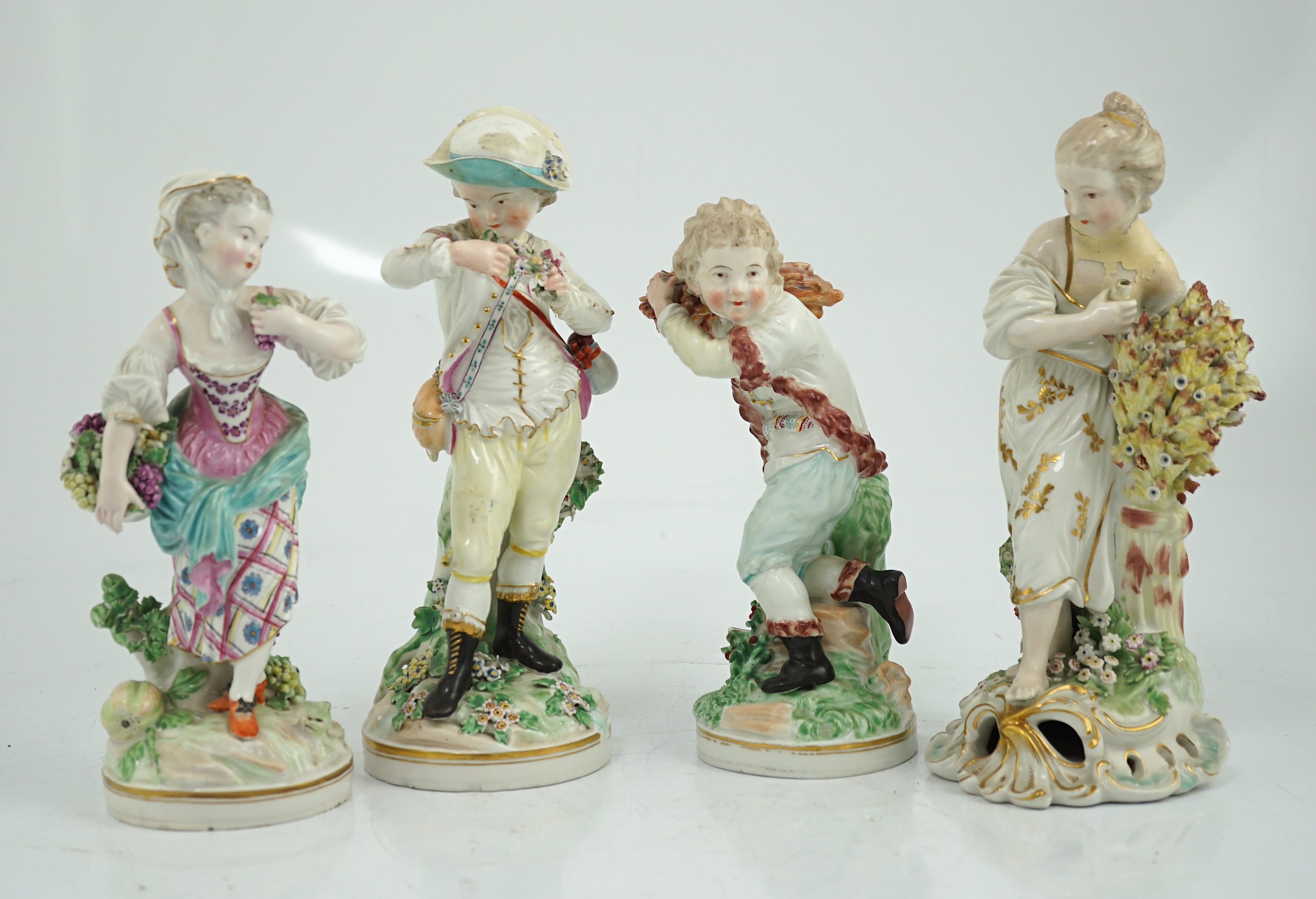 A composed set of four Derby figures emblematic of the Seasons, late 18th century, modelled by Pierre Stephan, the figures of Spring, Summer and Winter on circular bases, the figure of Autumn on a scrollwork base, 21cm t